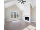 Bright living room with a cathedral ceiling, fireplace with white shiplap, and large windows offering a wood view at 154 Fox Hunt Dr, Mooresville, NC 28117