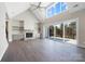 Open living room with fireplace, vaulted ceiling, hardwood floors and sliding doors to a large deck at 154 Fox Hunt Dr, Mooresville, NC 28117