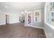 Bright living space with large windows, a modern chandelier, and elegant hardwood floors at 154 Fox Hunt Dr, Mooresville, NC 28117