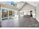 Bright open floor plan with hardwood floors, vaulted ceiling, living room, kitchen and sliding glass doors at 154 Fox Hunt Dr, Mooresville, NC 28117