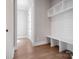 Bright mudroom features a built-in bench with storage and white shiplap, perfect for organization at 154 Fox Hunt Dr, Mooresville, NC 28117