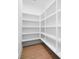 Walk-in pantry with custom-built shelving and wood floors, providing ample storage space at 154 Fox Hunt Dr, Mooresville, NC 28117