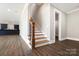 Elegant staircase with wood treads, white risers, and a dark wood banister at 154 Fox Hunt Dr, Mooresville, NC 28117