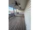 Enclosed back porch with multiple ceiling fans and natural wood flooring at 1638 Marmot Pl, Concord, NC 28025