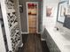 Charming bathroom featuring a classic vanity, shiplap accents, and a view into a walk-in closet at 1638 Marmot Pl, Concord, NC 28025
