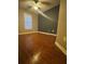 Well-lit bedroom features dark accent wall and beautiful wood flooring at 1638 Marmot Pl, Concord, NC 28025