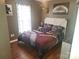 Cozy bedroom featuring a football-themed comforter and decor, complemented by warm, wood-look flooring at 1638 Marmot Pl, Concord, NC 28025