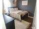 Cozy bedroom features a black queen bed, nightstand, a window, and neutral rug at 1638 Marmot Pl, Concord, NC 28025