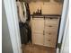 Organized closet with hanging storage and white wooden cabinet, providing efficient space for clothing and personal items at 1638 Marmot Pl, Concord, NC 28025