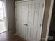 Hallway closet doors adjacent to wood table and window with blinds at 1638 Marmot Pl, Concord, NC 28025