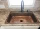 Kitchen area with a copper sink, granite countertops and stainless faucet at 1638 Marmot Pl, Concord, NC 28025