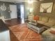 Cozy living room features wood floors, patterned rug, and neutral decor at 1638 Marmot Pl, Concord, NC 28025