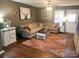 Living room boasts ample seating and natural light from surrounding windows at 1638 Marmot Pl, Concord, NC 28025