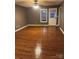 Well-lit living room features gorgeous wood flooring and a bright window at 1638 Marmot Pl, Concord, NC 28025