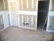 Unfinished bedroom with white door and an open closet space at 184 Oak Creek Rd, Statesville, NC 28625