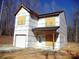 Home exterior featuring a white facade, covered windows, and a garage with surrounding trees at 184 Oak Creek Rd, Statesville, NC 28625