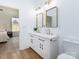 Bright bathroom features double sinks with stylish gold fixtures and hardware with wood-look floors at 205 Skyline Cir, Salisbury, NC 28146