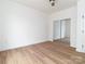 Minimalist bedroom with wood-look flooring and mirrored closet showcasing the spacious layout at 205 Skyline Cir, Salisbury, NC 28146