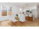 Bright dining area with a glass table and seating for eight; an open-concept kitchen in the background at 205 Skyline Cir, Salisbury, NC 28146