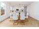 Bright dining area featuring a modern glass table and stylish white chairs, adjacent to the kitchen at 205 Skyline Cir, Salisbury, NC 28146