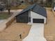 Newly constructed home with a modern design, paved driveway, and landscaped yard at 205 Skyline Cir, Salisbury, NC 28146
