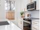 Well-lit kitchen showcasing white cabinets, quartz countertops, stainless steel appliances, and window view at 205 Skyline Cir, Salisbury, NC 28146