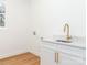 Clean and modern laundry area features white cabinets, gold hardware, a sink, and a countertop at 205 Skyline Cir, Salisbury, NC 28146
