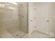 Clean and modern bathroom features tiled shower with glass door, bench and ample room at 2058 Skyhawk Dr, Lake Wylie, SC 29745
