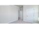 Well-lit bedroom featuring neutral walls, carpet flooring, and doorway with white trim at 2058 Skyhawk Dr, Lake Wylie, SC 29745