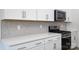Close up of a kitchen featuring quartz countertops, stainless appliances, and stylish backsplash at 2058 Skyhawk Dr, Lake Wylie, SC 29745