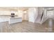Open concept living room with kitchen, staircase, and entrance, and hardwood floors at 2058 Skyhawk Dr, Lake Wylie, SC 29745