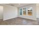Open living room featuring hardwood floors, neutral paint, and large windows to backyard at 2058 Skyhawk Dr, Lake Wylie, SC 29745