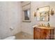 Charming powder room featuring a decorative vanity and ornate mirror at 20711 Bethel Church Rd, Cornelius, NC 28031