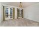 Bright bedroom with carpet, white shiplap walls, large windows, and beautiful outdoor views at 20711 Bethel Church Rd, Cornelius, NC 28031