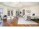 Bright primary bedroom with hardwood floors, chandelier, and access to outdoor views at 20711 Bethel Church Rd, Cornelius, NC 28031