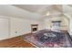 A bedroom with hardwood floors, fireplace, and a door to a balcony at 20711 Bethel Church Rd, Cornelius, NC 28031