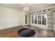 Elegant dining room featuring hardwood floors, large window, floral curtains, and a chandelier at 20711 Bethel Church Rd, Cornelius, NC 28031