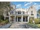Beautiful stone home with wrought iron railings, a balcony and columns at 20711 Bethel Church Rd, Cornelius, NC 28031