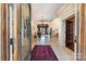 Grand foyer with a chandelier, staircase, tiled floors, and views into the living room at 20711 Bethel Church Rd, Cornelius, NC 28031
