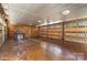Spacious three car garage featuring stained concrete flooring and wood paneling at 20711 Bethel Church Rd, Cornelius, NC 28031