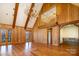 Spacious living room featuring hardwood floors, wood paneling, vaulted ceilings, and a unique chandelier at 20711 Bethel Church Rd, Cornelius, NC 28031
