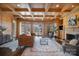 Bright living room with coffered wood ceiling, fireplace, and large windows offering serene outdoor views at 20711 Bethel Church Rd, Cornelius, NC 28031