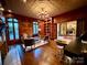 Elegant living room featuring wood paneling, coffered ceilings, and a decorative chandelier at 20711 Bethel Church Rd, Cornelius, NC 28031
