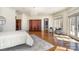 Spacious main bedroom featuring a chandelier, sitting area, hardwood floors and a decorative rug at 20711 Bethel Church Rd, Cornelius, NC 28031