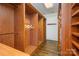 Custom walk-in closet with wooden shelving and drawers providing ample storage space at 20711 Bethel Church Rd, Cornelius, NC 28031