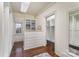Walk-in closet with custom white cabinetry, drawers, shelving, wood floors, and a window at 20711 Bethel Church Rd, Cornelius, NC 28031