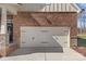 View of home and two-car garage with black decorative hardware at 2111 Augusta National Dr, Denver, NC 28037