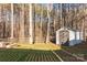 Spacious backyard with a storage shed and rustic wooden fence surrounded by mature trees at 214 Harbor Landing Dr, Mooresville, NC 28117