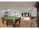 Finished basement featuring a pool table, a cozy seating area, and a bar, creating an inviting space for entertainment at 214 Harbor Landing Dr, Mooresville, NC 28117