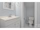 Classic bathroom with a clean white vanity, ample lighting, and a private toilet area at 214 Harbor Landing Dr, Mooresville, NC 28117